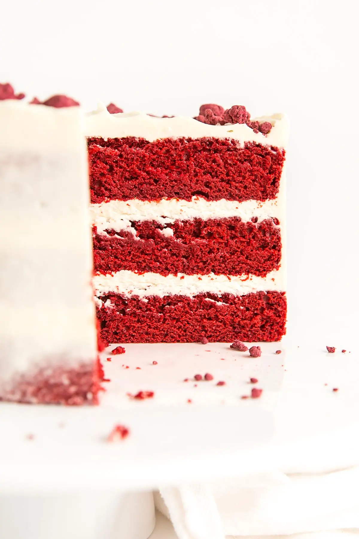 Cross section of cake showing three red velvet layers.