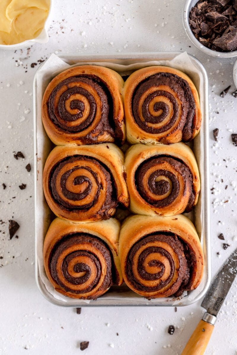 baked orange rolls ready for frosting