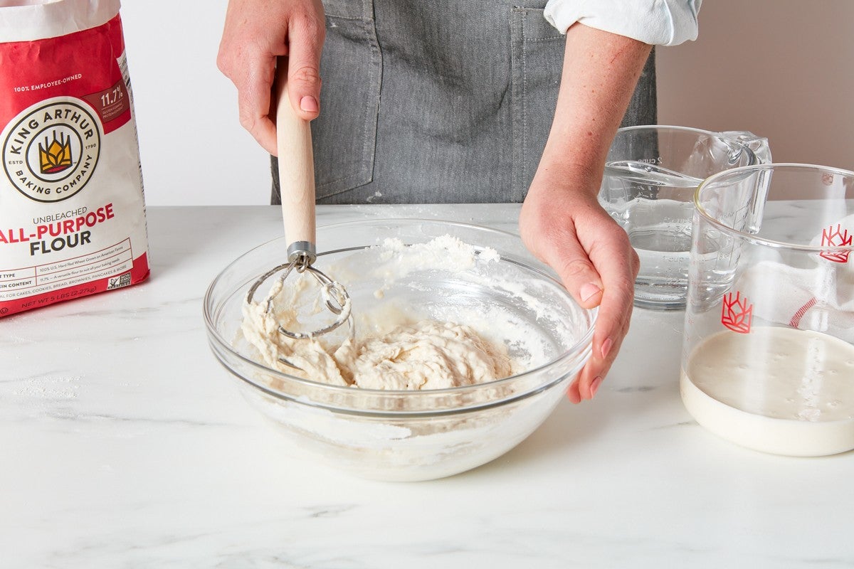 Mixing together sourdough starter to feed it