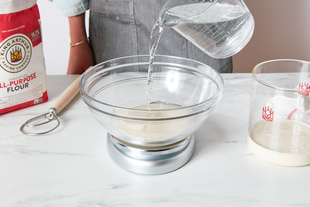 Adding water to feed sourdough starter