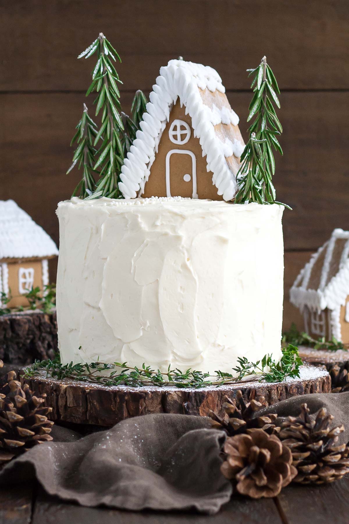 Cake with a gingerbread house on top.