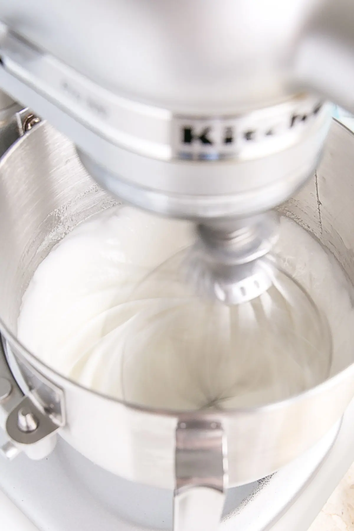 The meringue being whipped in the stand mixer.