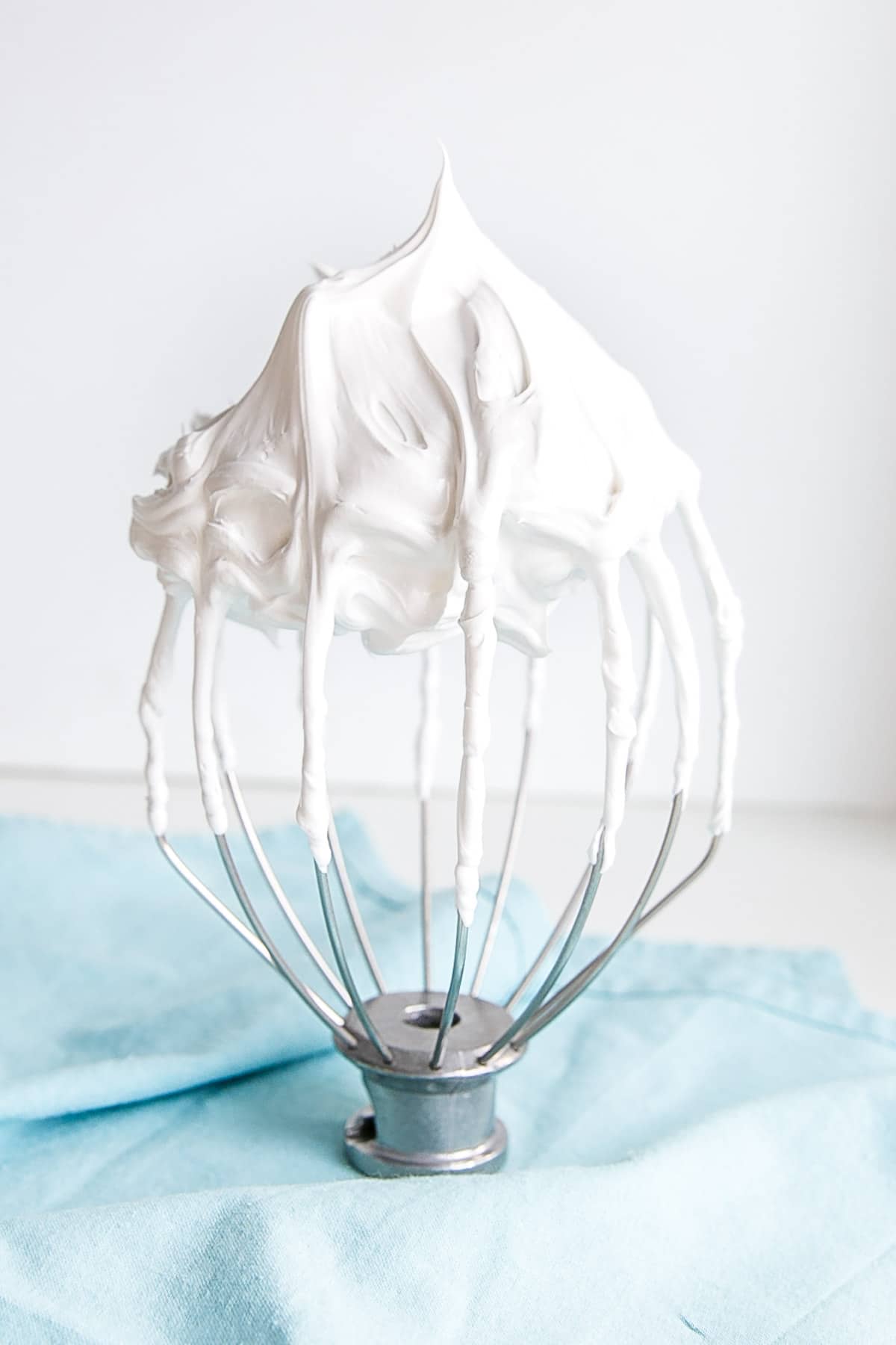 Meringue frosting on a stand mixer whisk.