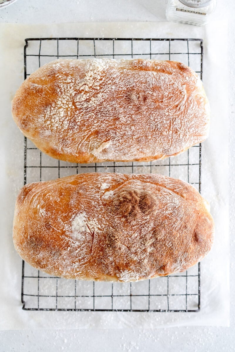 two loaves of ciabatta on rack