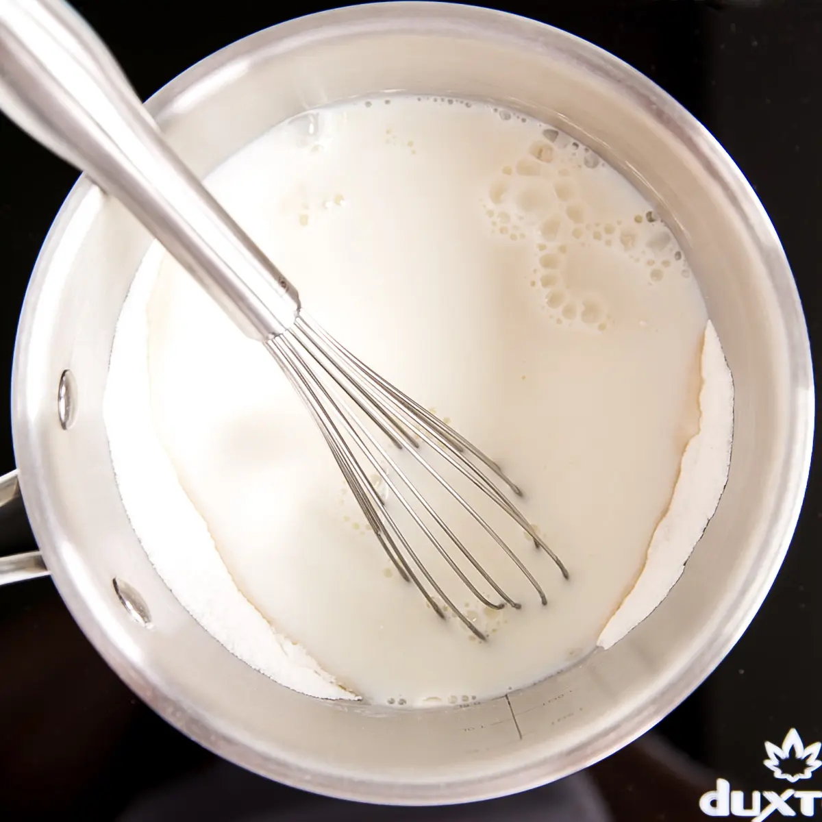 Milk added to the pot with the flour, sugar, and salt.