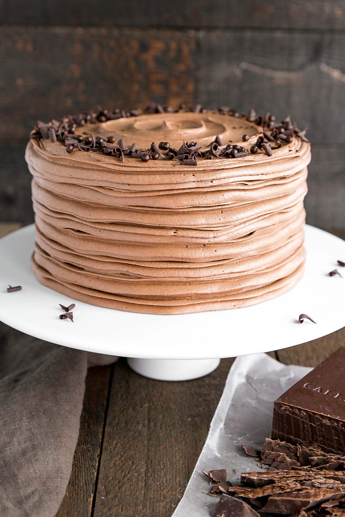 Angled shot of the cake on a white cake stand.