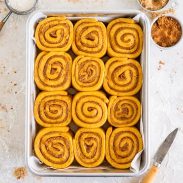 Pumpkin Cinnamon Rolls in a pan, ready to be baked