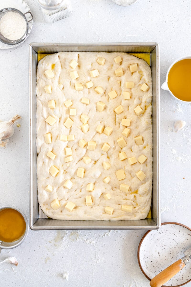 cheese chunks on dough ready to rise