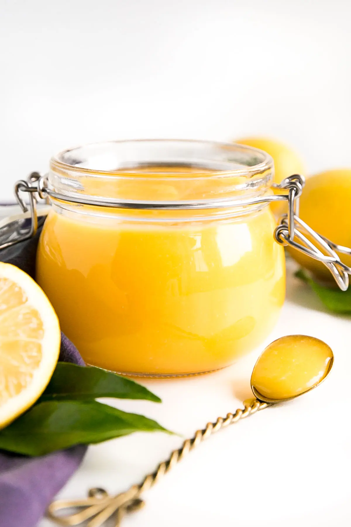 Lemon curd in an open glass jar.