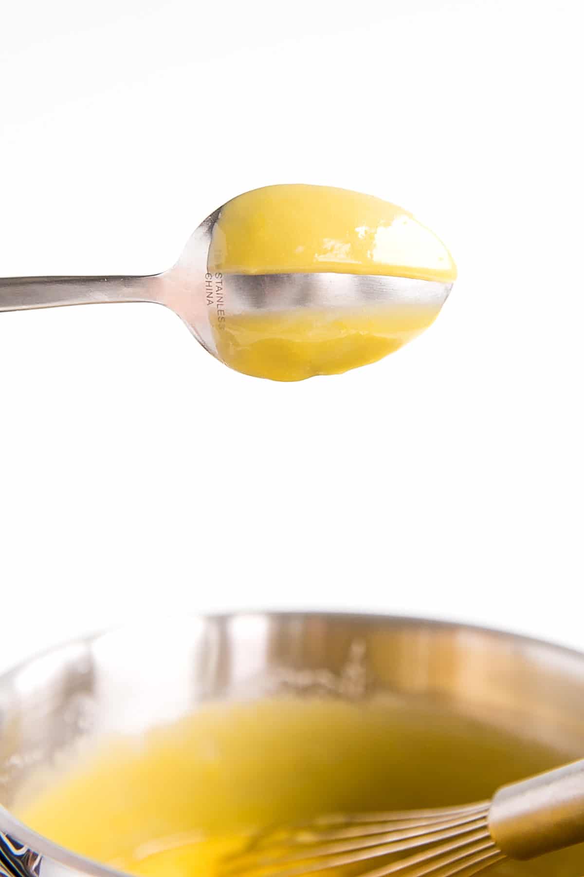 Spoon coated with lemon curd.