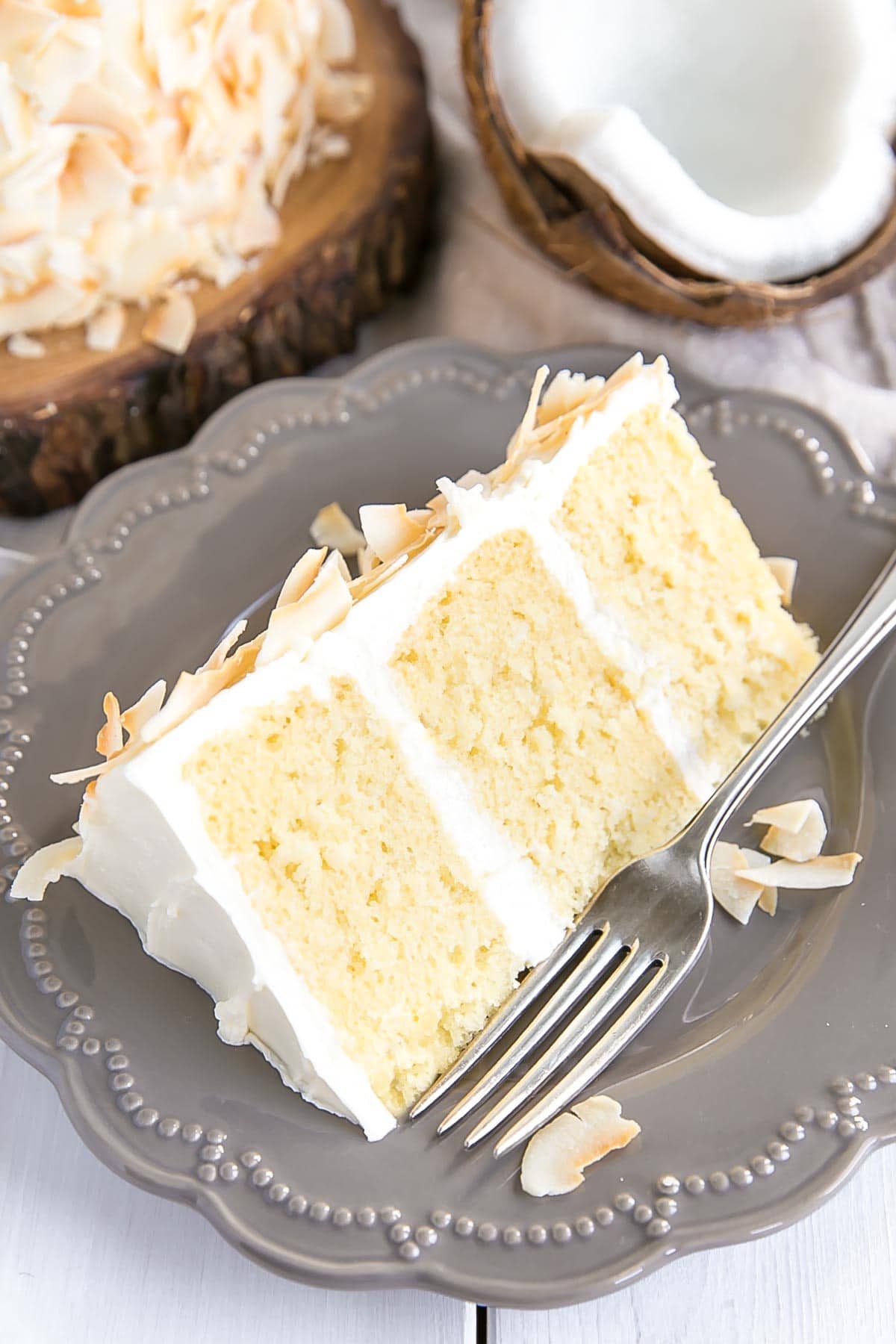 Slice of coconut cake on a plate.