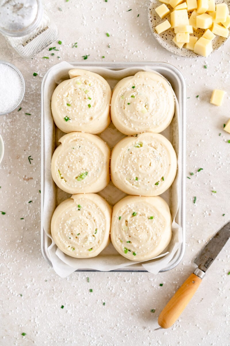 top down shot of buns with pretzel salt and chives